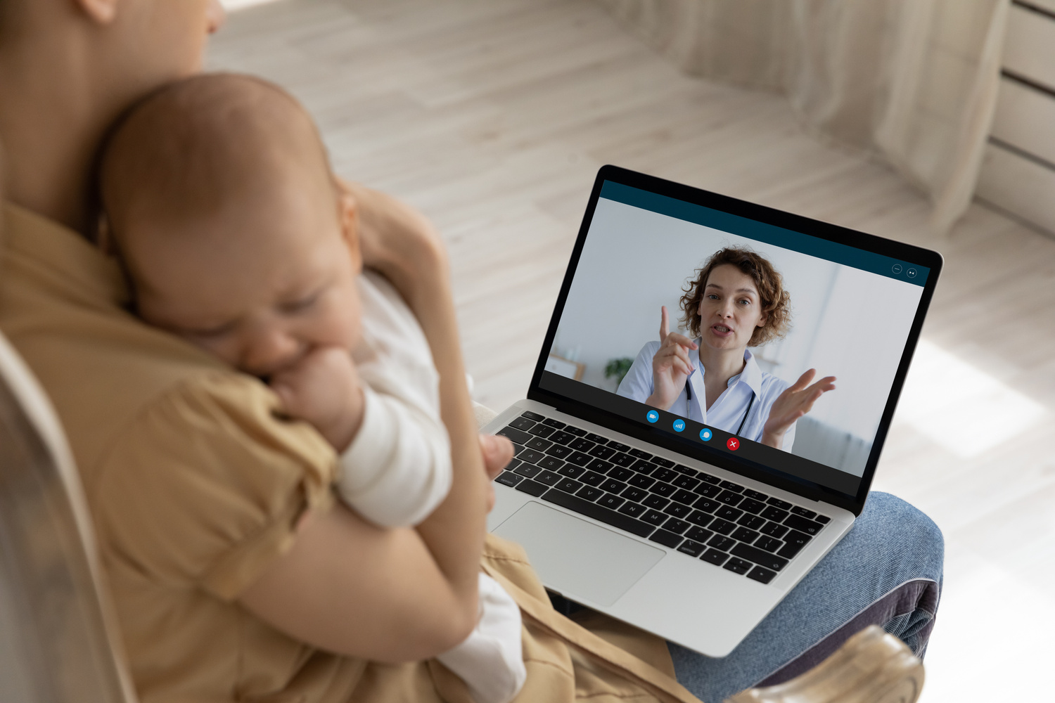 New mom holding her baby during an online therapy for new moms Los Angeles session